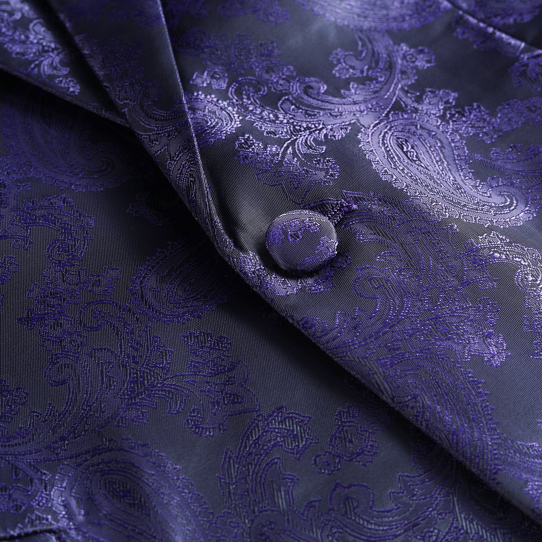 Purple # Men's slim fit 2-piece paisley fashion suit with notch lapel and single-breasted button closure, purple patterned formal blazer jacket with four-button cuffs and fully lined interior, matching flat-front trousers for party, wedding, prom and special occasions, isolated on white background.