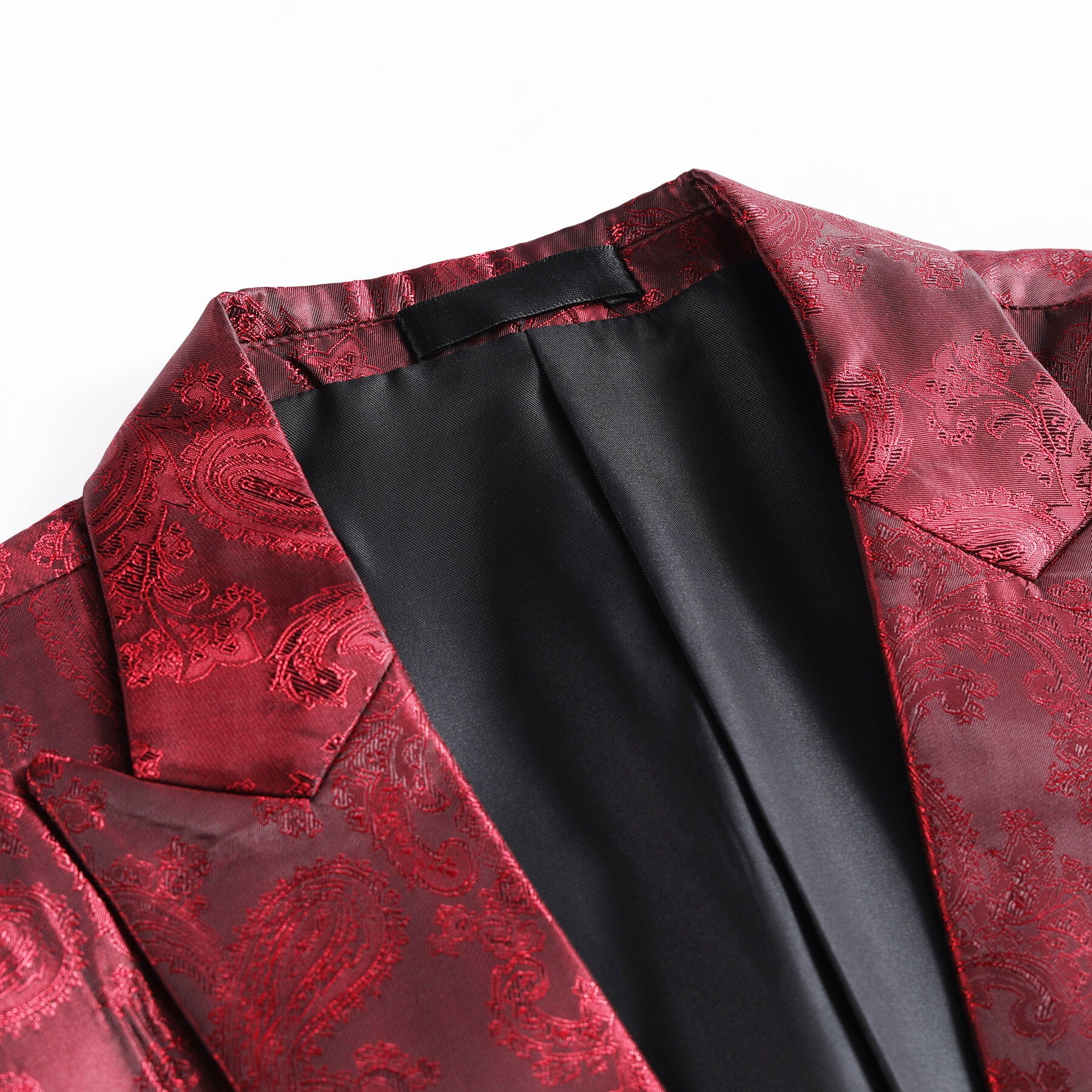 Red # Men's slim fit 2-piece paisley fashion suit with notched lapel and single-breasted button closure, red patterned formal blazer jacket with four-button cuffs and fully lined interior, matching trousers for party, wedding, prom and special occasions, isolated on white background.