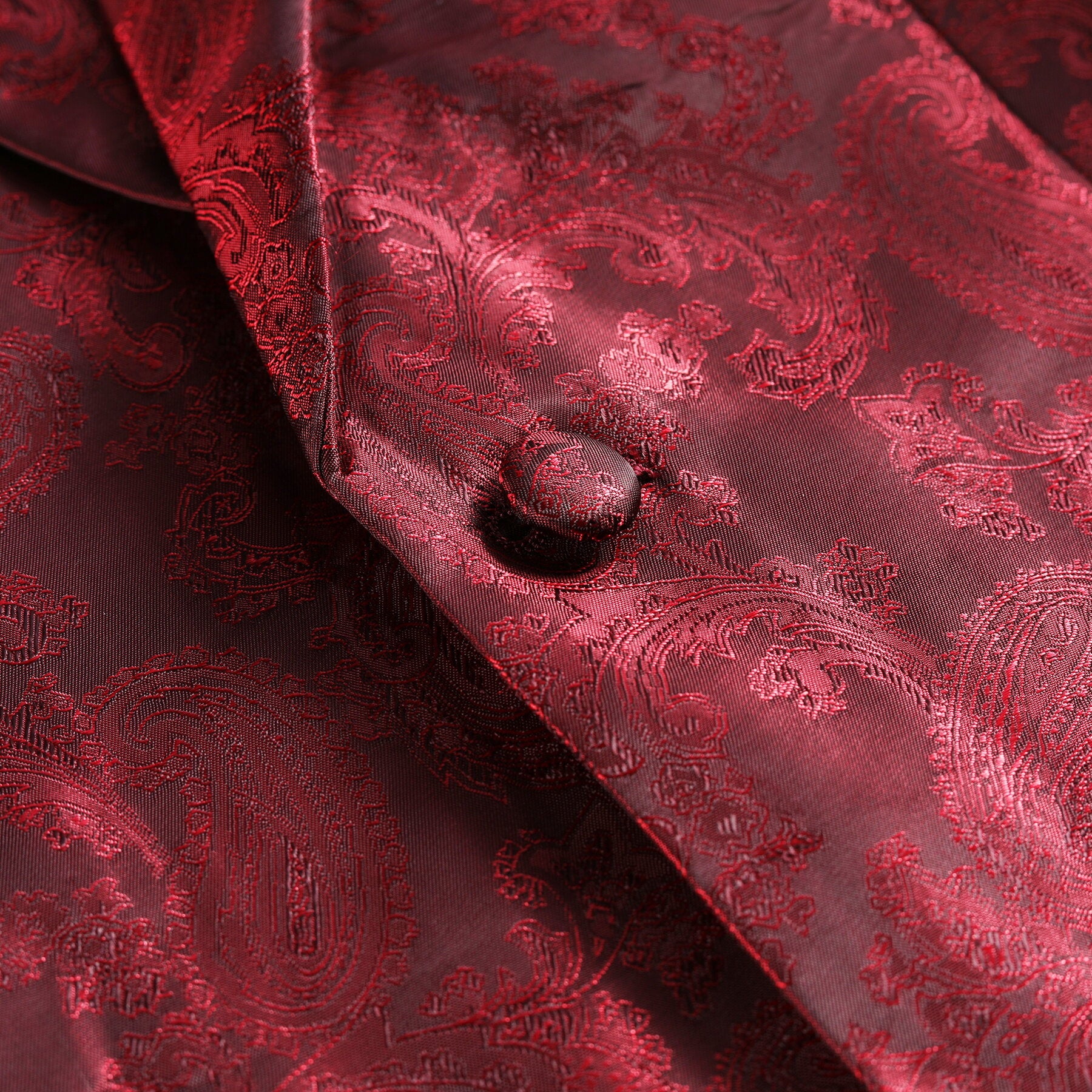 Red # Men's slim fit 2-piece paisley fashion suit with notched lapel and single-breasted button closure, red patterned formal blazer jacket with four-button cuffs and fully lined interior, matching trousers for party, wedding, prom and special occasions, isolated on white background.