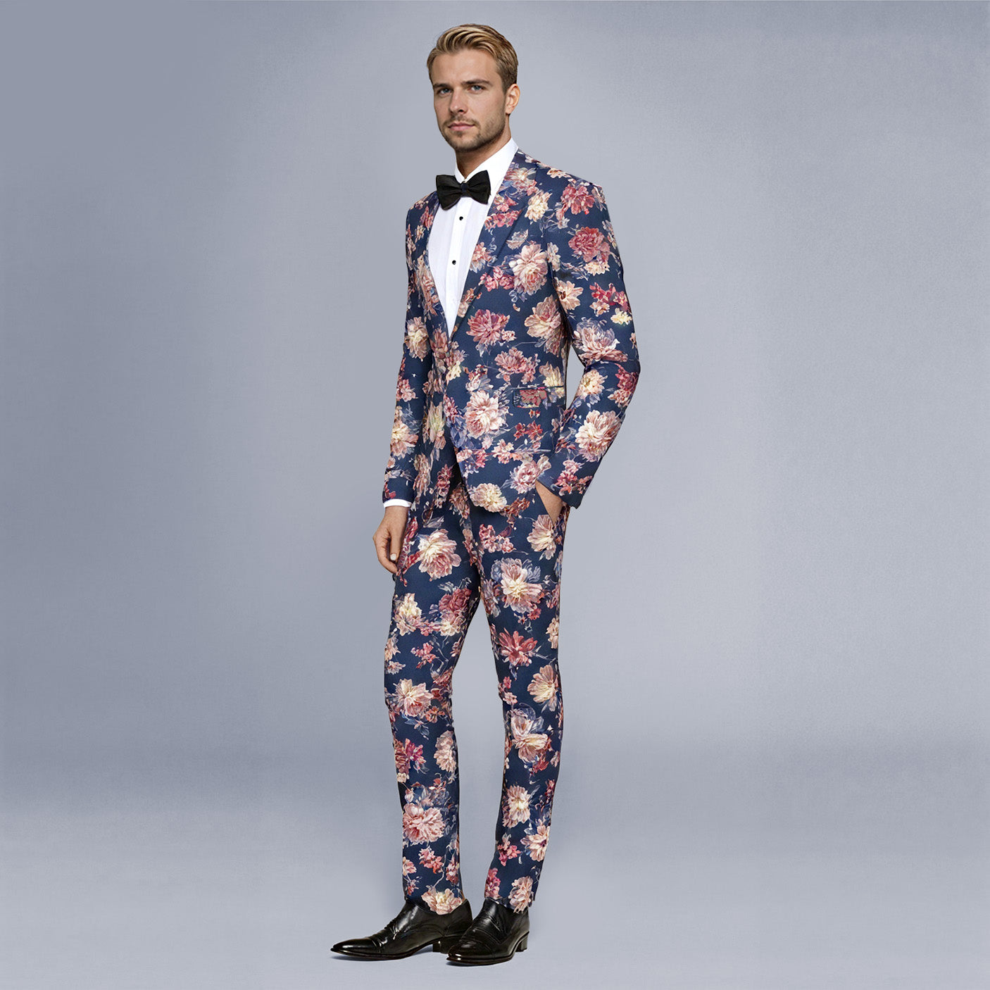 Navy # Men's slim fit 2-piece floral print suit with notched lapel and four-button cuffs, navy patterned blazer jacket with matching flat-front trousers with extended waist strap for wedding, prom, party and formal occasions, isolated on white background.