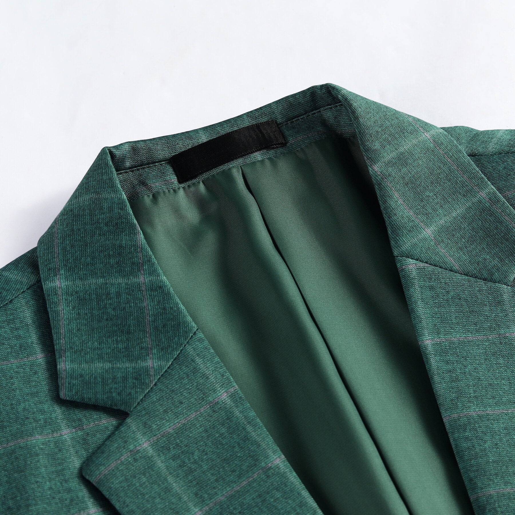 Green Plaid # Men's slim fit 3-piece green plaid modern suit with peaked lapel and button closure, classic yet contemporary formal blazer jacket with matching vest and flat-front trousers with extended waist strap for business, wedding, prom and daily wear, isolated on white background.