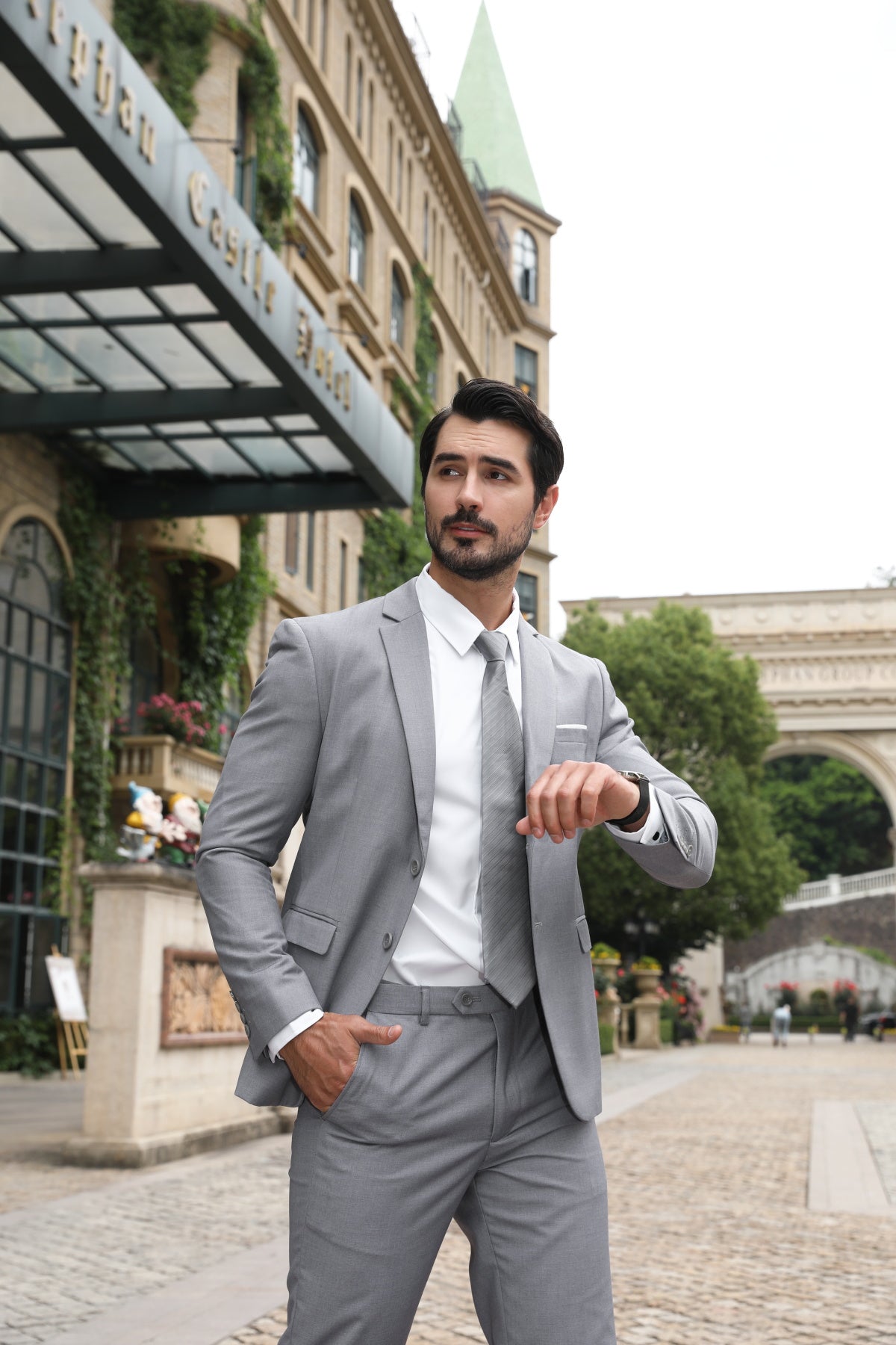 Light Grey # Men's slim fit 2-piece suit with peaked lapel and two-button closure, light grey formal blazer jacket with four-button cuffs and matching flat-front trousers with extended waist strap, classic elegant business wear for office, wedding, prom and daily occasions, isolated on white background.