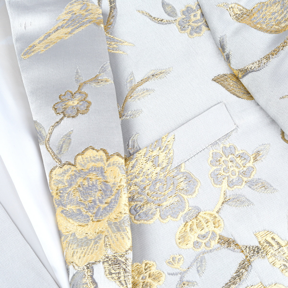 White # Men's one-button notched lapel embroidered blazer with single-breasted closure and slim fit, soft and breathable polyester spandex sport coat with elegant embroidery for party, prom, banquet, show, festival and special occasions, isolated on white background.
